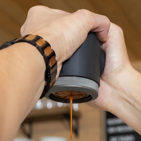 pressing espresso from a portable espresso maker