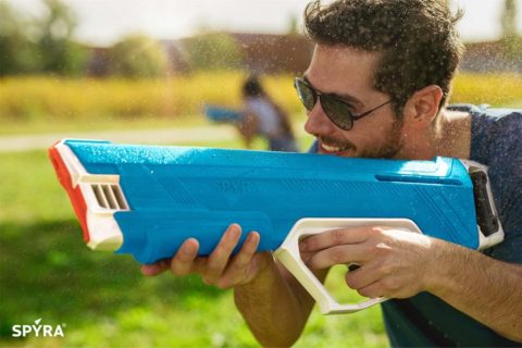 Man firing the best electric water gun - Spyra