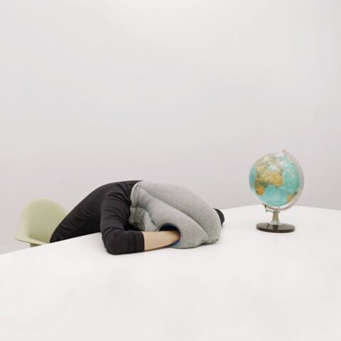 Best Neck Pillow for Travel Student using the Ostrich pillow, the best neck pillow for travel