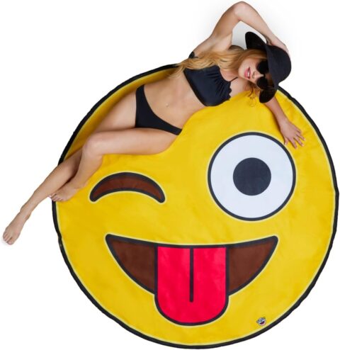 This Giant Beach Towel : Bringing Fun to the Shore Woman laying on a giant beach towel with a smiley face on it