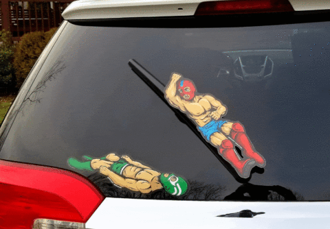 Funny Car Gift Idea: Luchador Windshield Wiper Covers Animated GIF of luchador windshield wiper covers, showing a red-masked wrestler delivering an elbow drop onto a green-masked opponent every time the rear wiper moves.