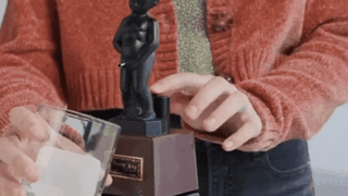 Funny peeing liquor dispenser pouring a drink into a glass
